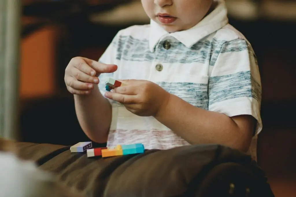 Photo by Caleb Woods boy with Tylenol Autism holding block toy