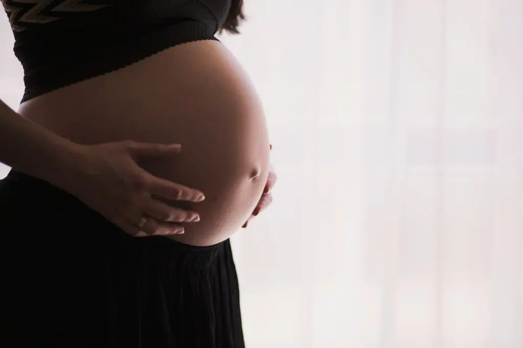 Photo by freestocks Worried woman holding stomach, Tylenol Autism, Tylenol ADHAD
