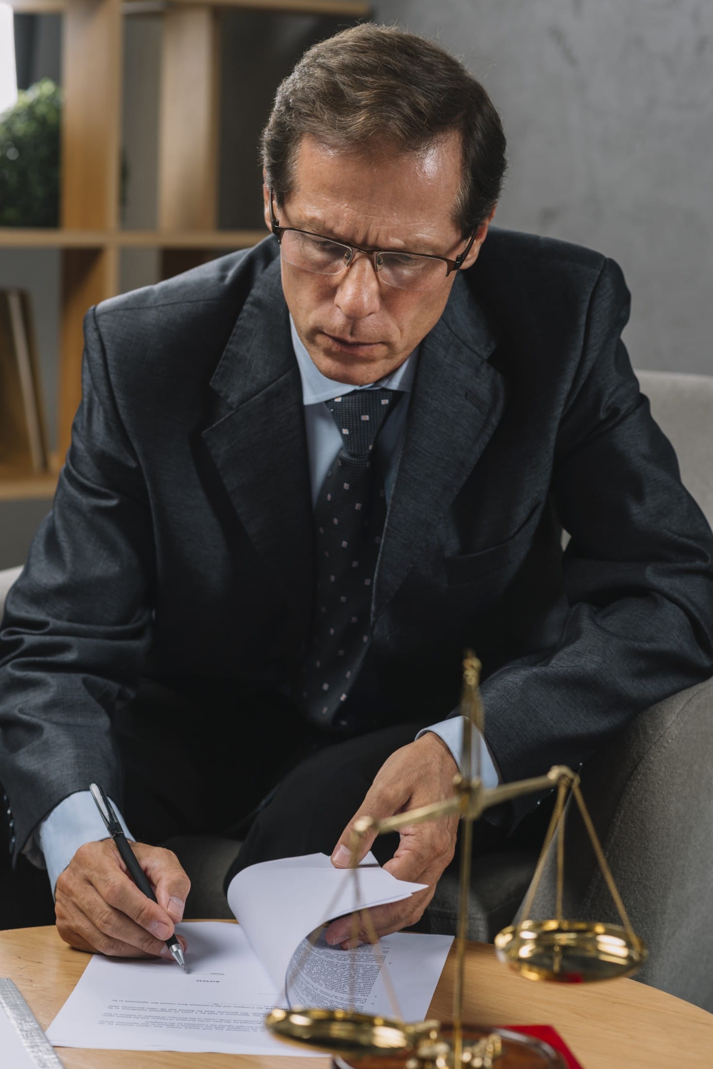 serious-mature-male-lawyer-signing