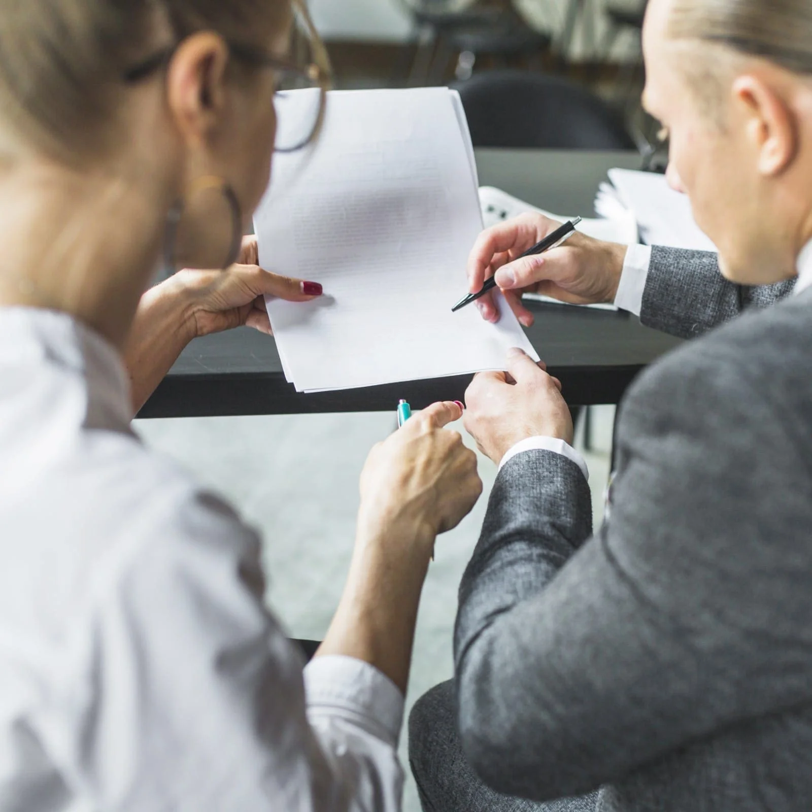 attorney-reviewing-document-with-client attorney reviewing document with client